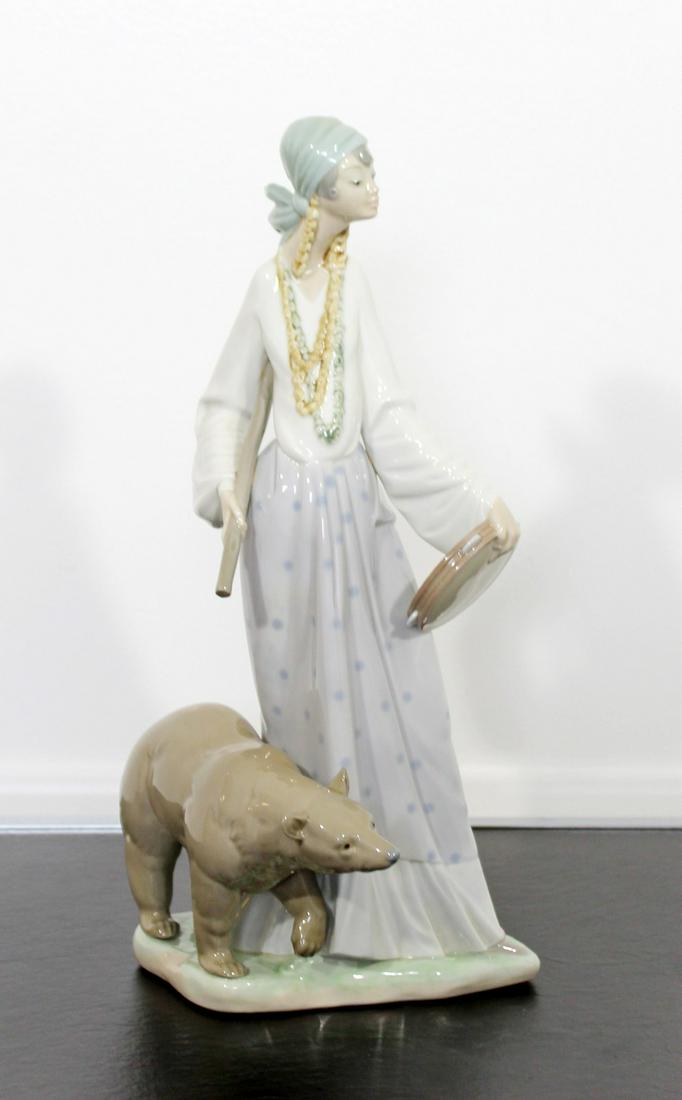 Porcelain Table Sculpture Signed Lladro Gitana: For your consideration is a lovely, porcelain table sculpture of a woman and a bear, entitled "Gitana Caminante," stamped Lladro, hand made in Spain, circa the 1970s. In excellent condition. The dimen