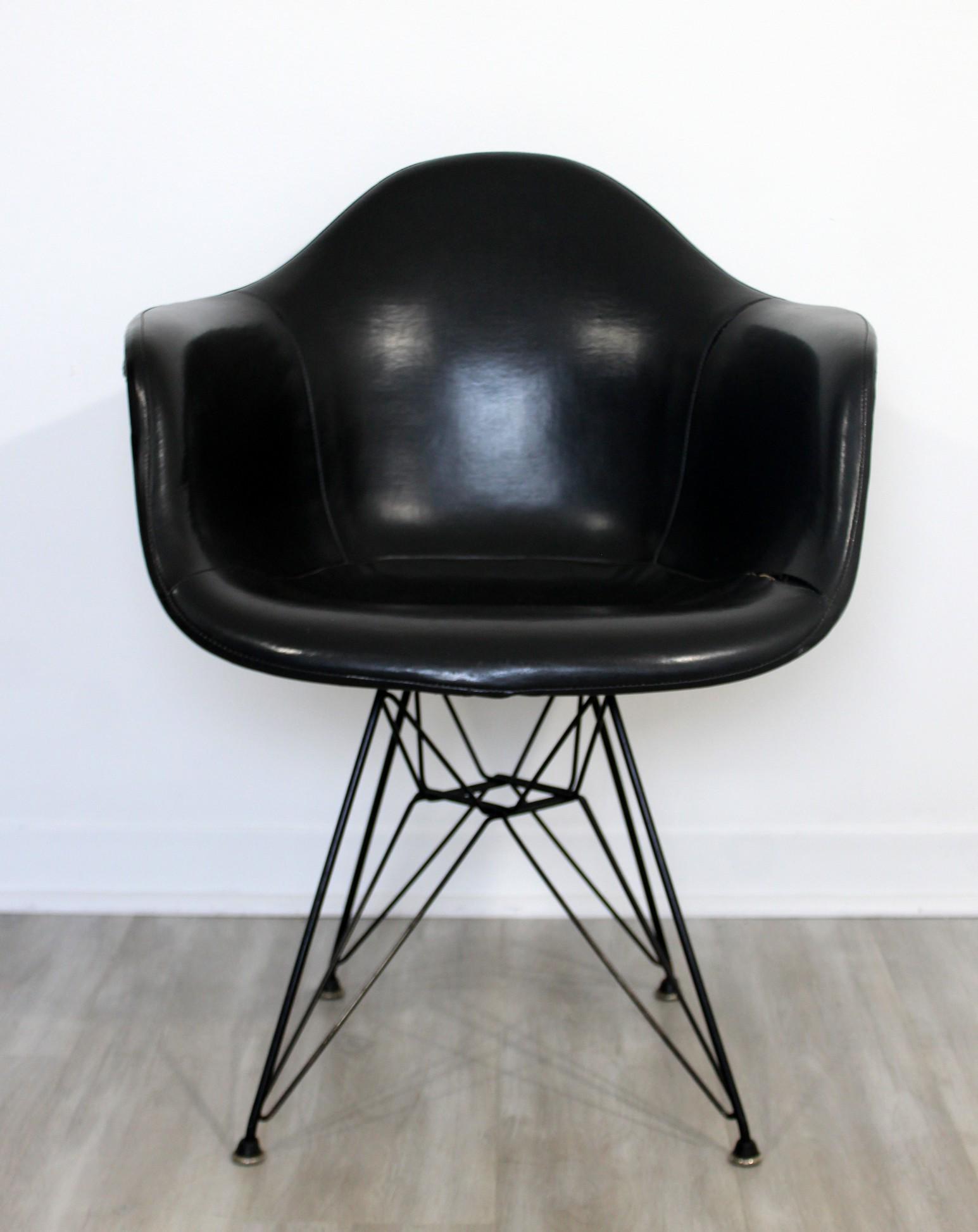 Early Charles Eames Eiffel Tower Base Leather Armchair: For your consideration is an early, Charles Eames armchair, with an "Eiffel Tower" base, circa the 1950s. In vintage condition. The dimensions are 25" W x 19" D x 31" B.H. x 25.5" A.H. x 18" S.H.