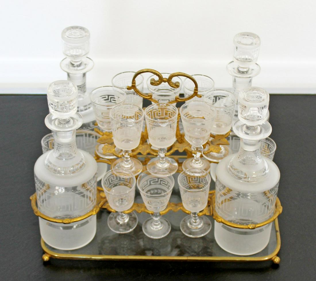 Deco Nouveau Gilded Tantalus Glass Liquor Cabinet: For your consideration is a stunning, gilded metal and glass, tantalus liquor cabinet barware set, circa the 1930s. In very good antique condition. The dimensions are 11" W x 7.5" D x 8.5" H.