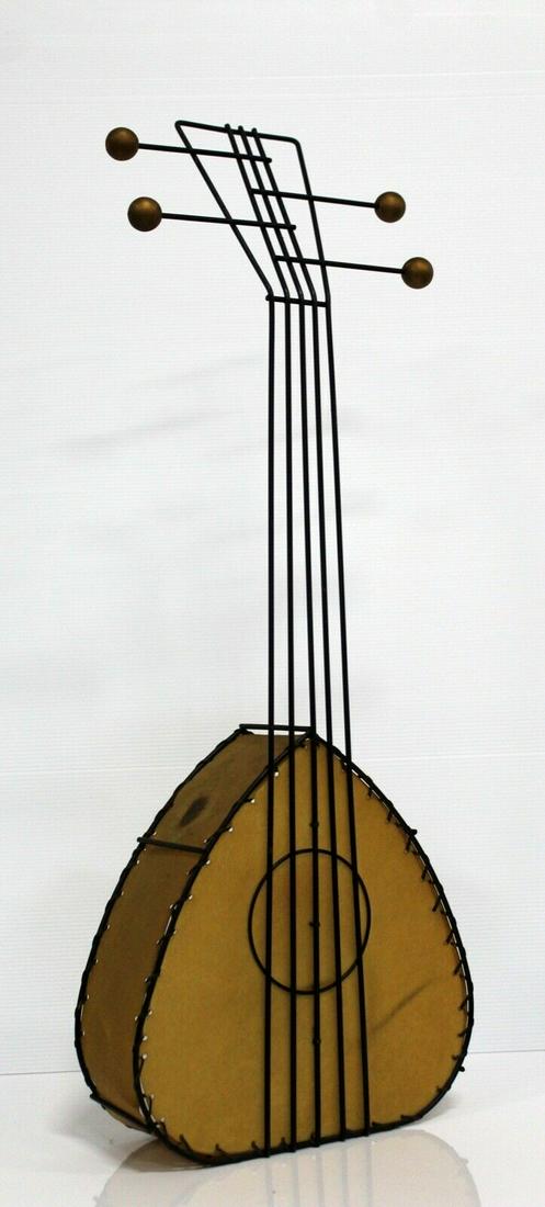 Mid Century Modern Frederick Weinberg Wire Parchment Sculpture Guitar Lamp: An amazing throwback to the mid century modern era with this corded lamp in the shape of a guitar or mandolin made by Frederick Weinberg. The shade consists of whip stitched parchment and framed in bl