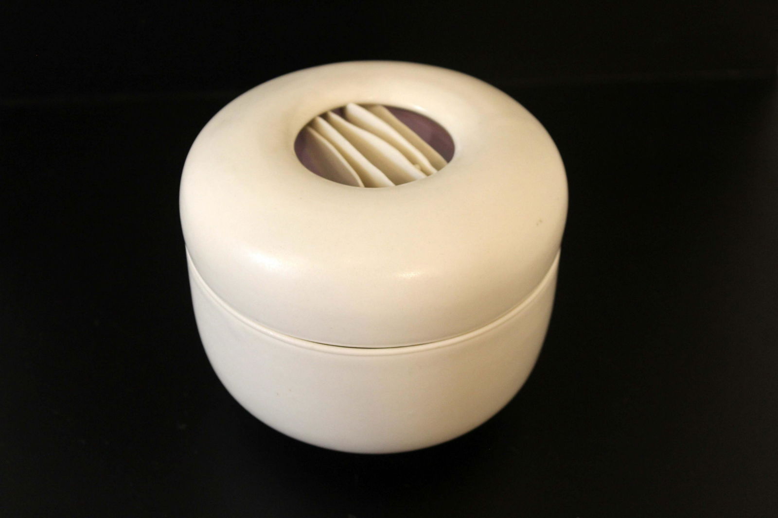 Joan Lurie Signed Porcelain Lidded Vessel with Ribbon Design: A chic porcelain lidded vessel sculpture by Joan Lurie. Signed on bottom. The lid of the vessel has an organic waved ribbon design in the center. From a private collection. Dimensions: 3.75h x 4.75dia