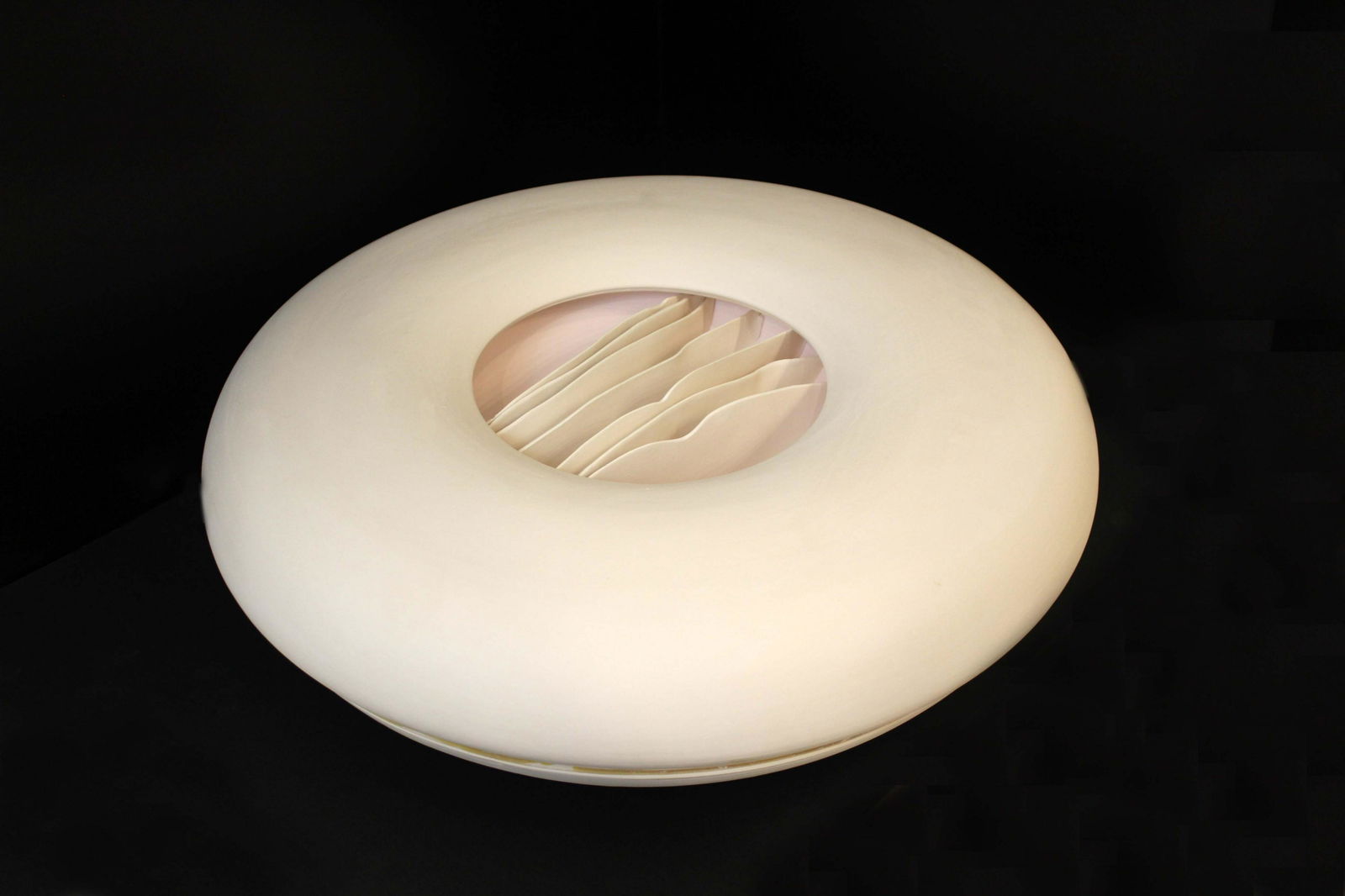 Joan Lurie Signed Porcelain Sculpture with Ribbon Design 1987: An elegant porcelain vessel sculpture by Joan Lurie. Signed on bottom with a 1987 date. The sculpture is a circular vessel with a waved ribbon design in the center. From a private collection. Dimensio