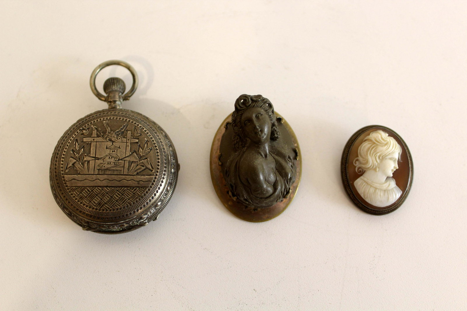 Vintage Set of Victorian Cameo Brooch with Engraved Pocket Watch Jewelry: A dainty set of Victorian cameo brooch pins with an engraved pocket watch. A nostalgic set of jewelry for someone who appreciates a vintage aesthetic. From a private collection. Dimensions: 1.25h x 1w
