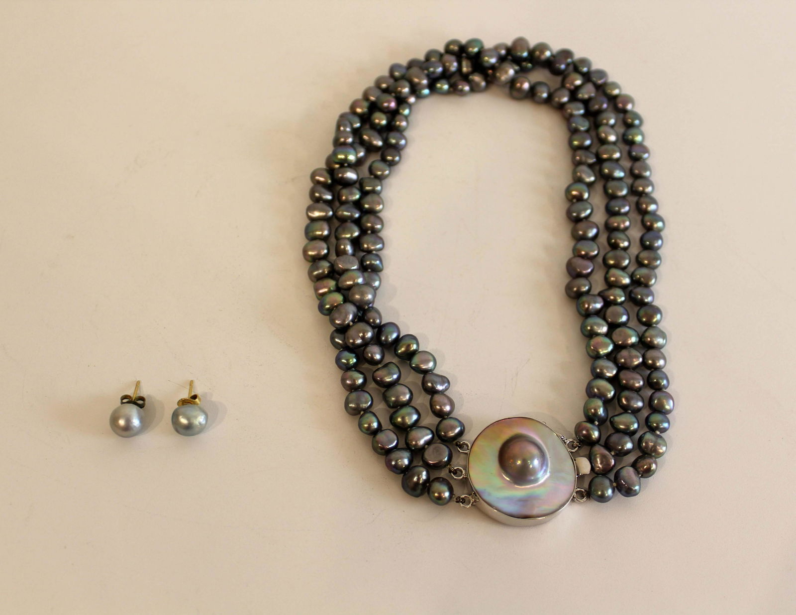 Vintage Fresh Water Grey Moby Pearl Necklace and Earrings Jewelry: A stunning set of vintage fresh water grey Moby pearl necklace and earrings. Triple stranded with a large sterling silver Moby pearl clasp. From a private collection. Dimensions: 6l x 6.5diam / .75h x
