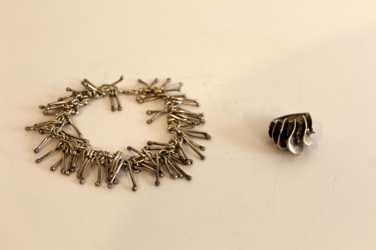 Vintage Sterling Silver Bracelet and Ring 925 Jewelry: An artful pair of vintage sterling silver - a modern designed ring with a swirl design and a bracelet with eclectic dangling components. From a private collection. The ring is a size 5/6, and the brac