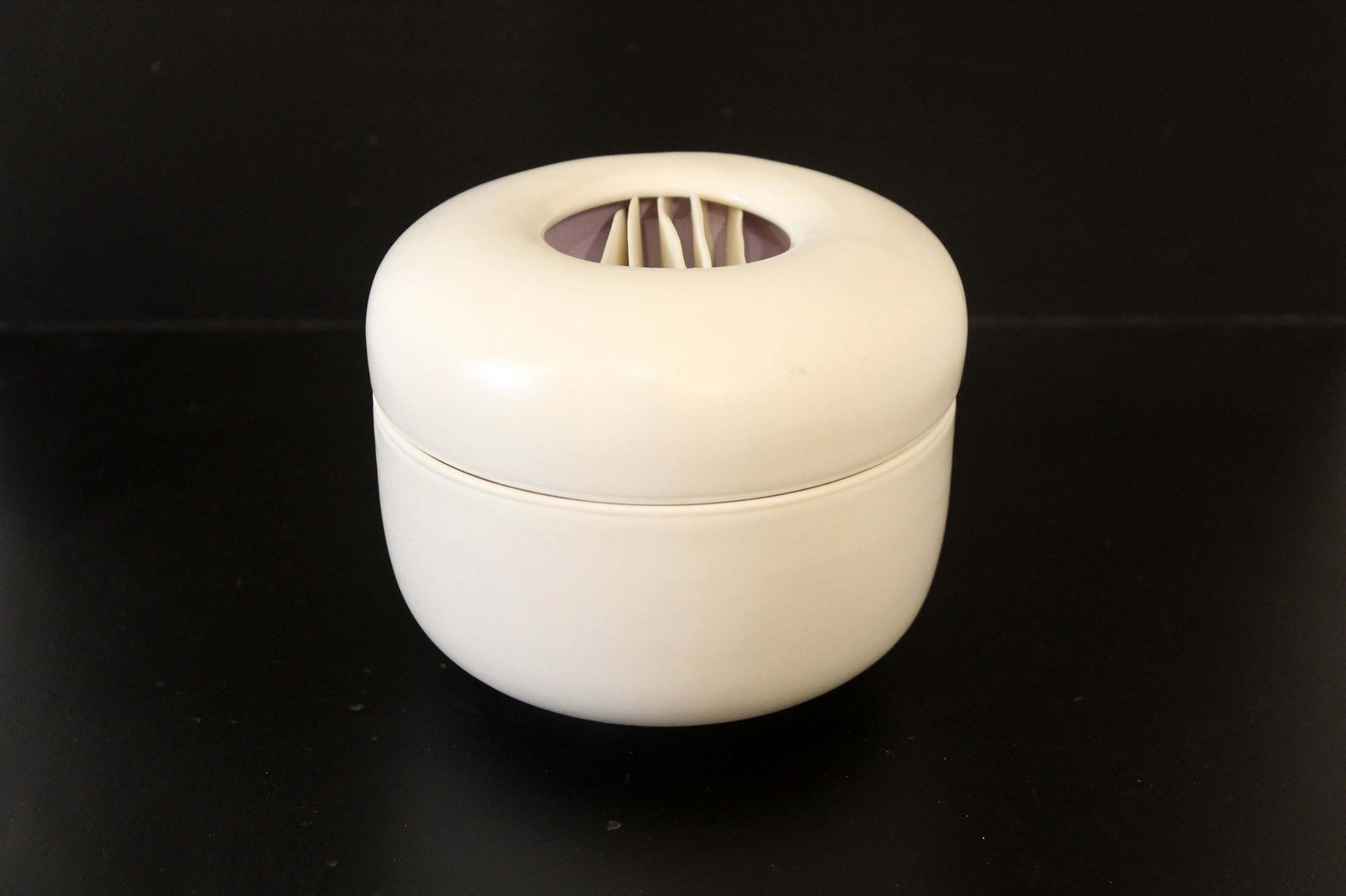 Joan Lurie Signed Contemporary Postmodern Porcelain Lidded Vessel with Ribbon Design 1980s: A chic porcelain lidded vessel sculpture by Joan Lurie. Signed on bottom. The lid of the vessel has an organic waved ribbon design in the center. From a private collection. Dimensions: 3.75h x 4.75dia