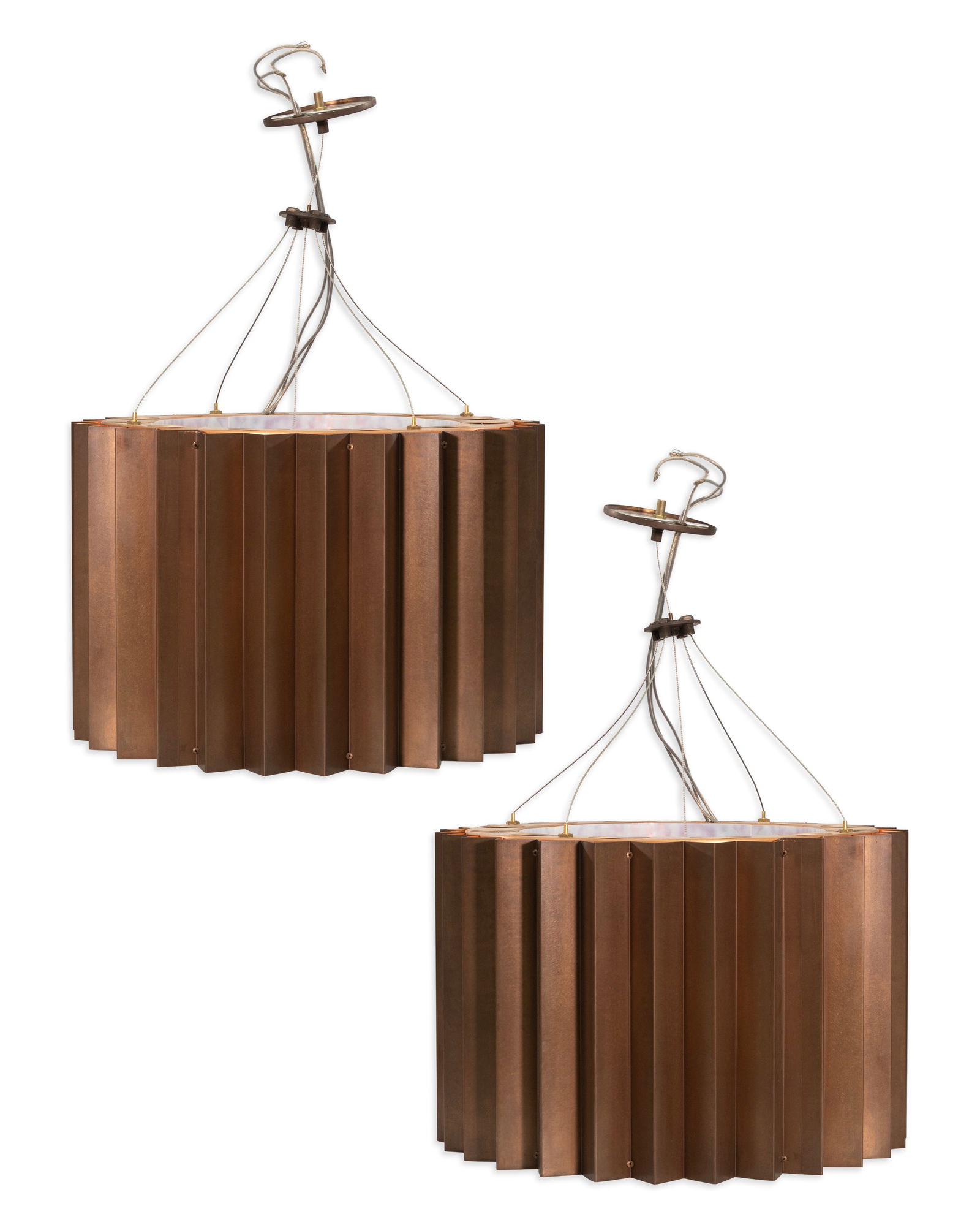 Michael McEwen Gear Suspension Pair of Bronze Finished Chandeliers: Striking and industrial in design, this pair of chandeliers by Michael McEwen features sculptural metal shades with a bold, pleated form and a rich bronze-toned finish. Suspended by exposed cables, th