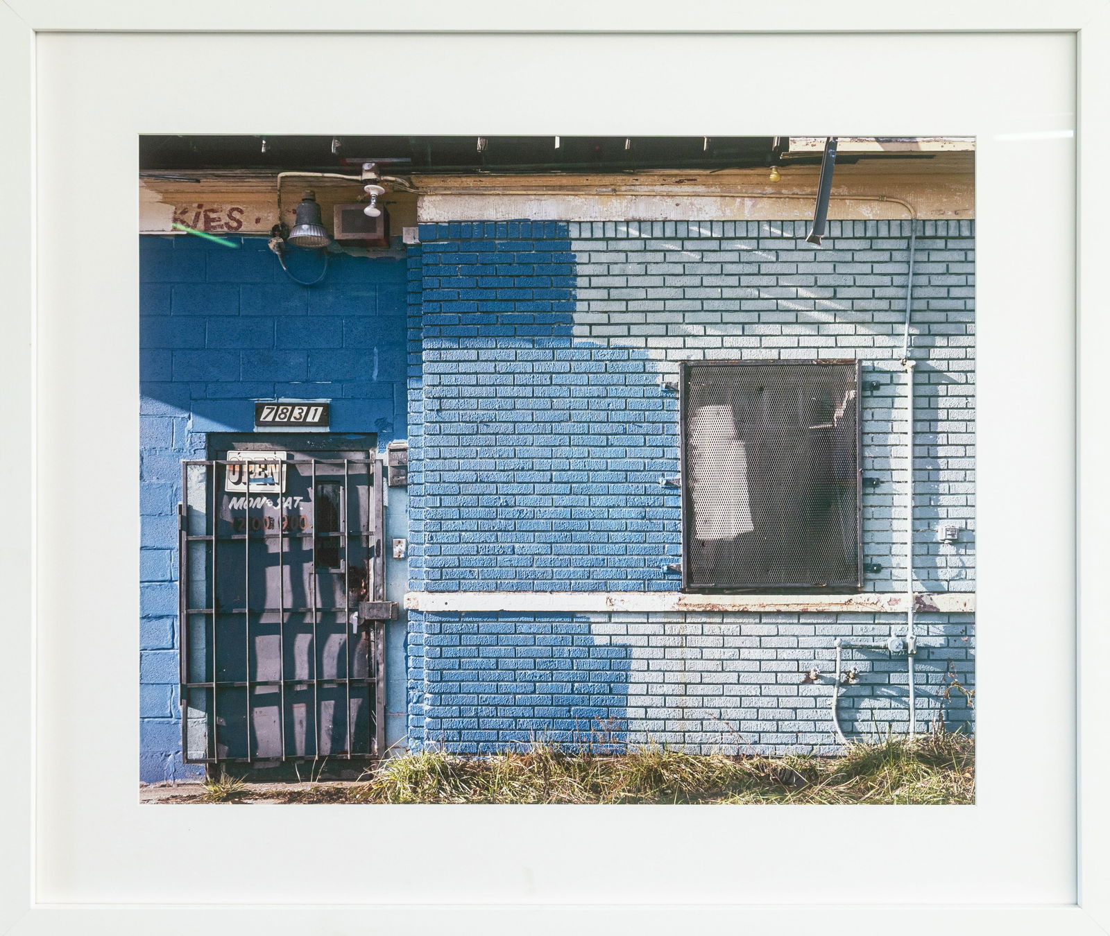 Eleanor Oakes, Charlevoix at Beals November, 2015, Photograph on Archival Paper: A color photograph on archival paper titled “Charlevoix at Beals November (2015)” by Eleanor Oakes. This photo captures a quiet urban façade defined by varied shades of blue brickwork