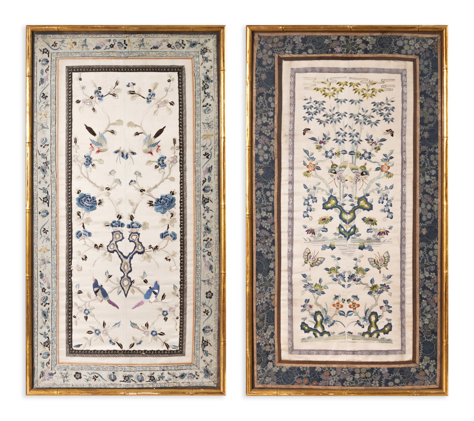Pair of Antique Silk Embroidered Kimono Sleeves, Framed - Traditional Japanese Textiles: A preserved pair of antique silk kimono sleeves, each intricately hand-embroidered with traditional Asian motifs. One features blue floral sprays with perched birds, while the other presents a more el