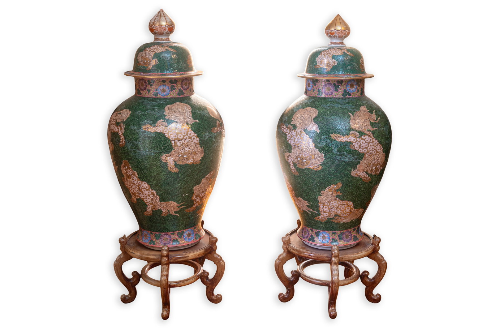 Pair of Monumental Japanese Imari Floor Vases (47”) on Wooden Stand, 19th Century: Monumental pair of Japanese Imari-style covered floor vases featuring richly decorated surfaces with stylized guardian lion motifs set against a deep green scrolling ground accented with gilt and mult