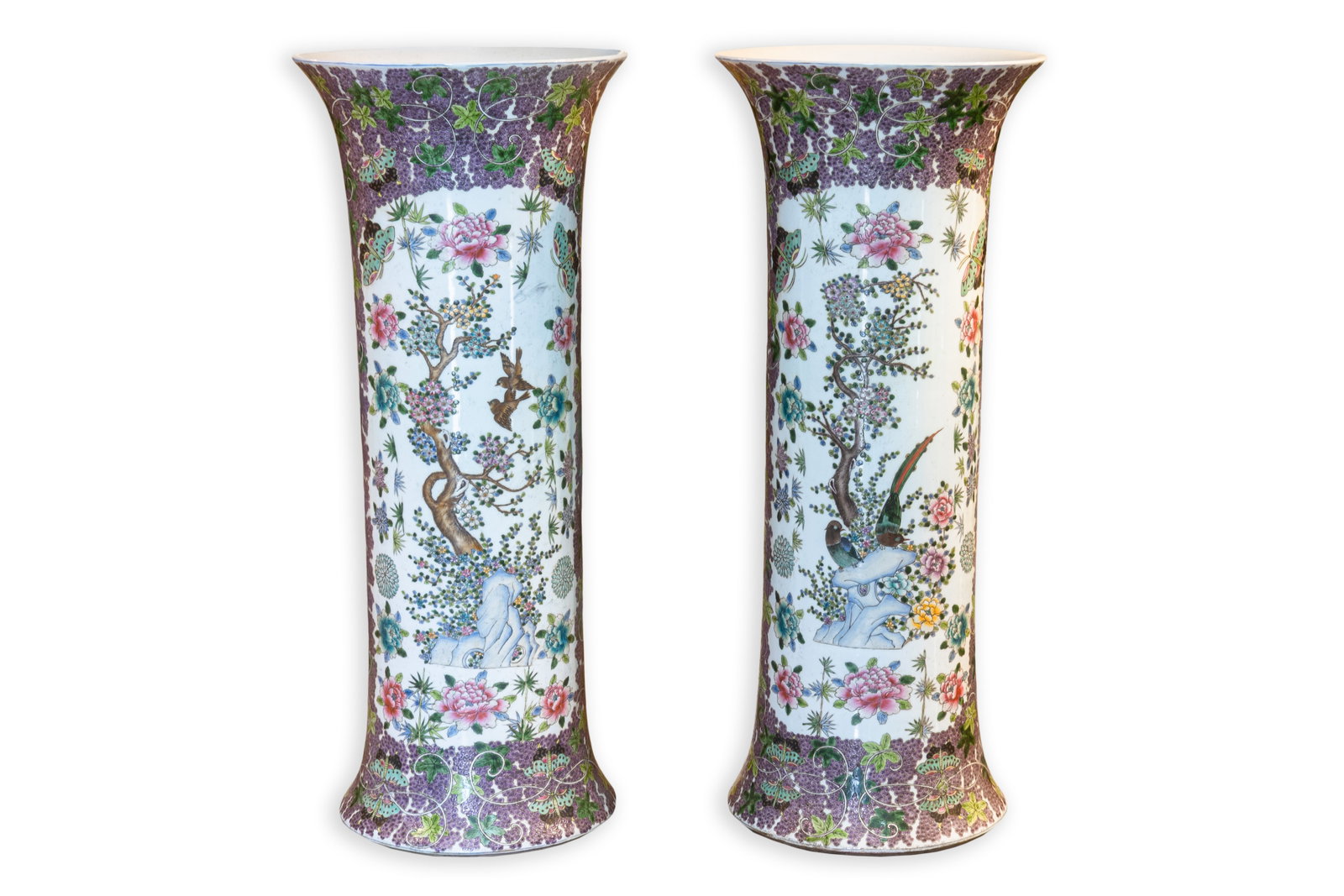Pair of Chinese Polychrome Floral and Bird Porcelain Floor Vases, Late 20th Century: Pair of tall Chinese porcelain floor vases decorated with finely detailed floral, butterfly, and avian motifs in vibrant polychrome enamels. The elongated trumpet-form bodies feature flowering branche