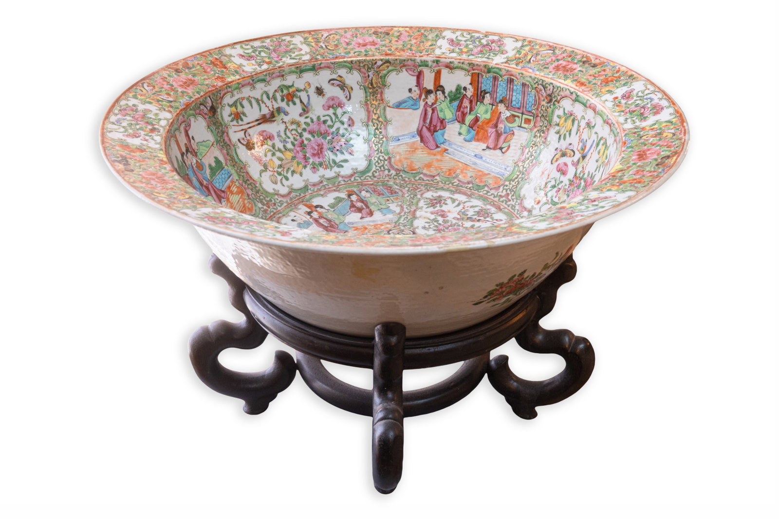 Chinese Rose Medallion Porcelain Bowl on Carved Hardwood Stand, Late 19th Century: Late 19th century Chinese Rose Medallion porcelain bowl richly decorated with alternating figural court scenes, birds, and floral reserves in a vibrant famille rose palette. The wide interior and rim 