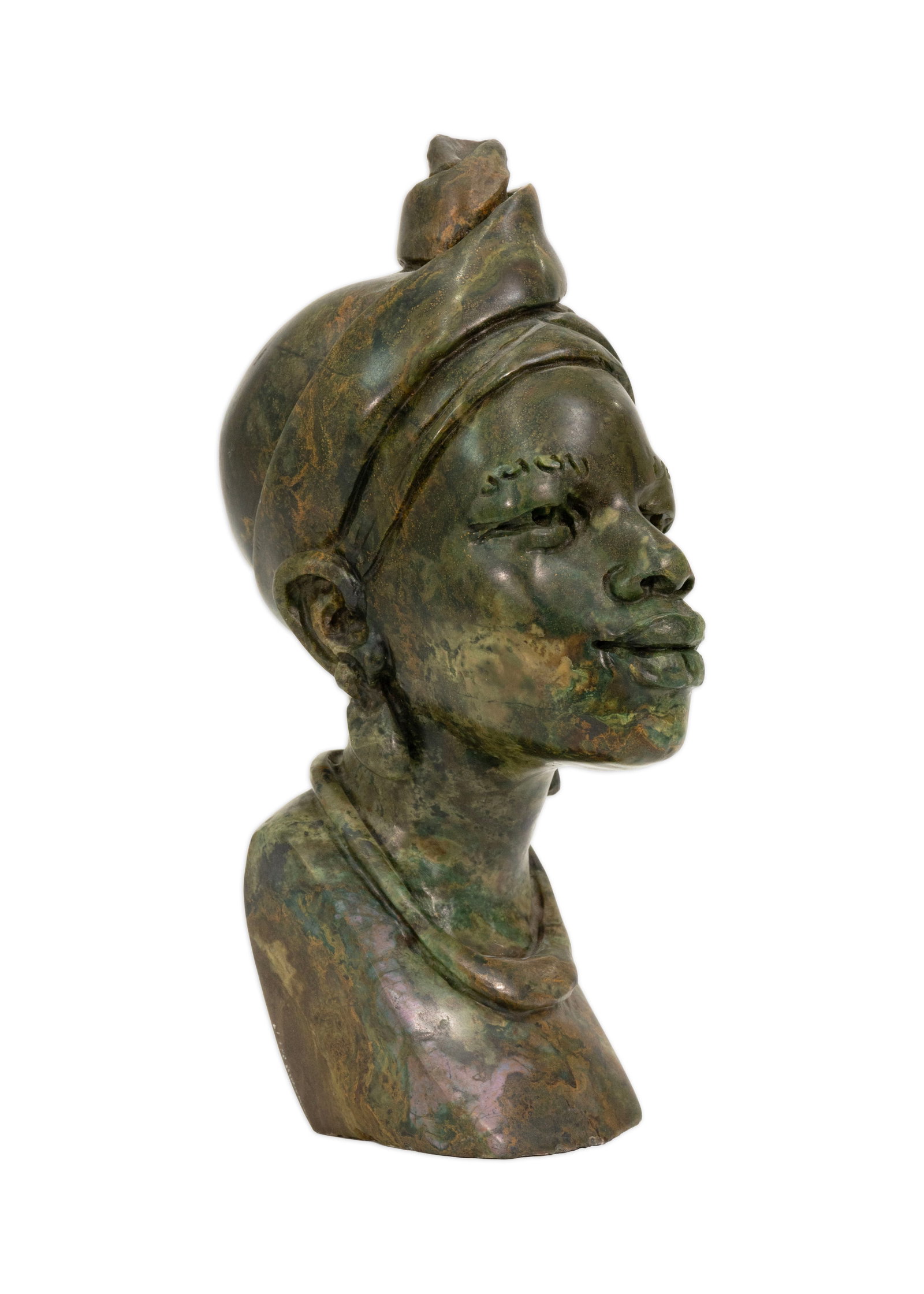 African Verdite Stone Bust of a Turkana Tribesman Hand-Carved Sculpture Signed Justin: Hand-carved verdite stone bust depicting a Turkana tribesman, signed “Justin” along the shoulder. Executed in richly mottled green and brown verdite, the sculpture portrays a stylized male