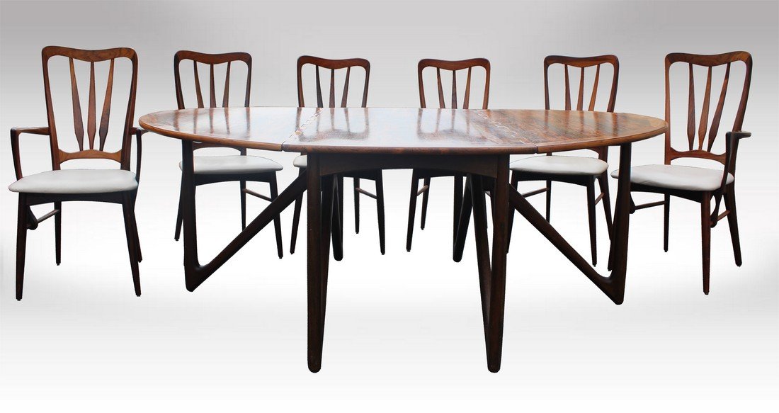 Kurt Ostervig Rosewood Dining Set Table & Chairs: a rosewood dining table designed by Kurt Ostervig. The Gatefold legs are of solid rosewood, and the table can change from a compact form to an impressive dining table that will seat eight. In addition