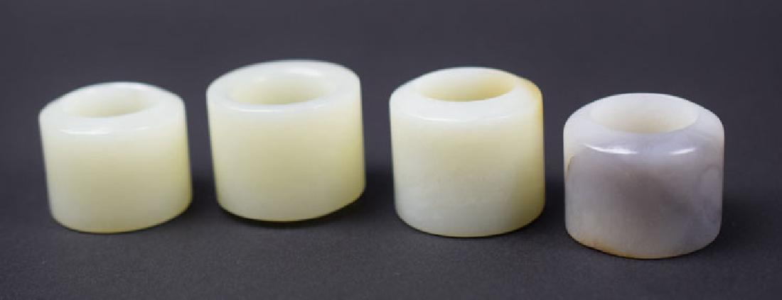 Four Chinese carved white jade archer's rings (1 of 4)