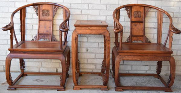 Pr. Chinese carved Huanghuali wood armchairs with a: Pr. Chinese carved Huanghuali wood armchairs with a horseshoe shaped back, pierced conforming splat, box stretchers,and a matching tea table.Chair size, 39 1/2"H x 28 1/2"L x 22"W table size 30 1/2"H