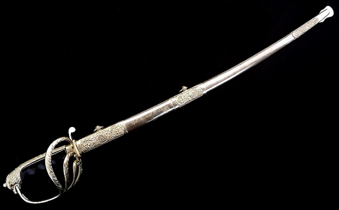 1902 Model Presentation American Cavalry Officer's: 1902 Model Presentation American Cavalry Officer's Sword. In nickeled steel mounts with eagle head pommel having red stone eyes. Blade with fine quality etched decorations and maker mark. Scabbard hav