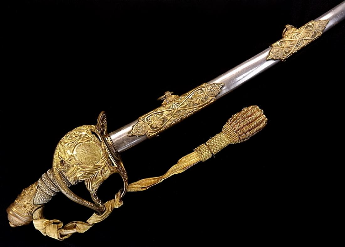 1872 Model US Cavalry Officers Presentation Grade Sword: In fire gilt brass mounts with lovely high relief details, fine sting ray skin grip. Blade in near mint condition with crisp etched decorations of patriotic motifs and foliage, maker marked to Ridaboc
