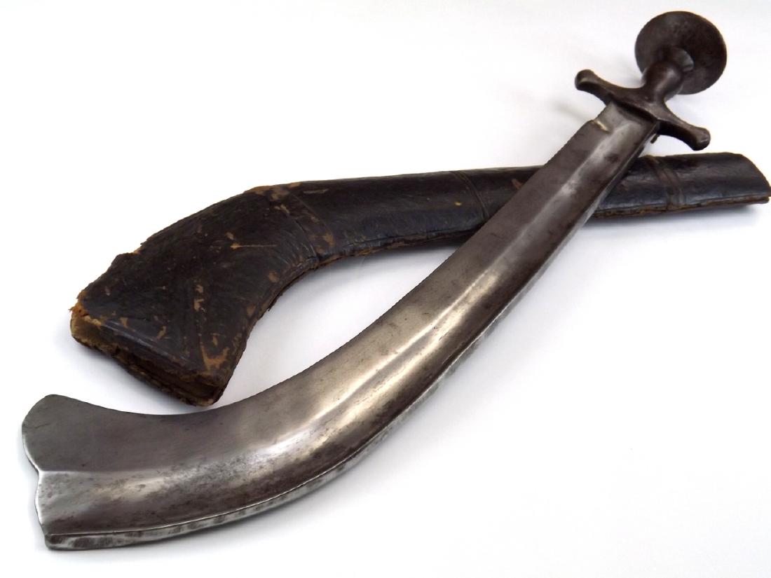 18th-19th C. Indian Nepalese Battle KORA Sword with: 18th-19th C. Indian Nepalese Battle KORA Sword with Original Scabbard. A massive fighting example with a solid steel hilt of traditional Indian style and an exceptionally thick and heavy hatchet blade