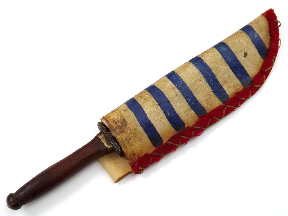 19th C. Native American Indian Used Knife Dagger in: 19th C. Native American Indian Used Knife Dagger in Flag Painted Decorated Hide Sheath. An unusual trade knife with distinctively shaped single edged blade and brass mounted wooden grip. Tang end is f