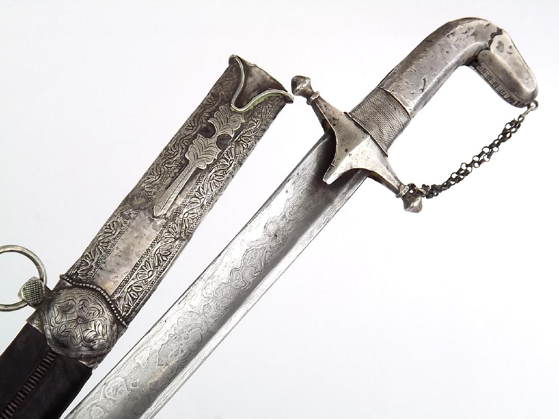 Good 18th-19th C. Islamic Arabic Damascus SAIF Shamshir: Good 18th-19th C. Islamic Arabic Damascus SAIF Shamshir Sword. In its silver furniture with elements of Niello enamel decorations to scabbard, mounted with a curved large fullered blade exhibiting act