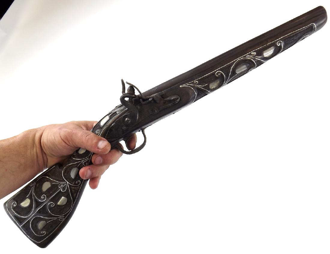 Large 19th C. Islamic Arabic or Afghanistan Flint-lock: Large 19th C. Islamic Arabic or Afghanistan Flint-lock Pistol . Of a crude local Arabic or Afghani manufacture with simply carved wooden stock inlaid with thick silver wire and mother of pearl section