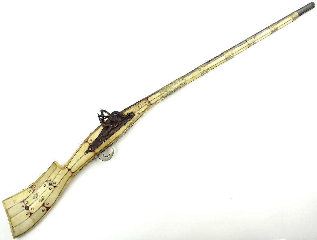 19th C. Islamic Arabic Snaphaunce Lock Rifle in Camel: 19th C. Islamic Arabic Snaphaunce Lock Rifle in Camel Bone Mounts. A primitive Arabic rifle with a crude snaphaunce firing mechanism in its full stock covered in camel bone sections, bound by the low 