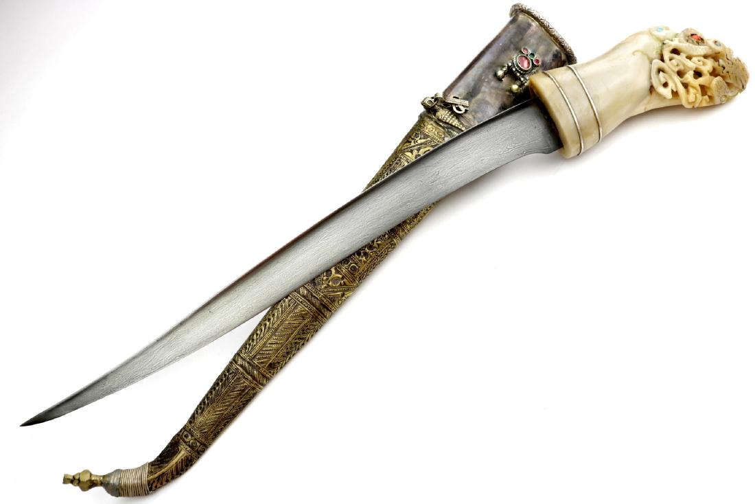 Interesting 19th C. Islamic Silver & Gem Stones mounted: Interesting 19th C. Islamic Silver & Gem Stones mounted Dagger with a Chinese Carved Jade Grip & Wootz Damascus Blade. Total Length (inside scabbard if present) : 20", Blade Length : 13 3/4"