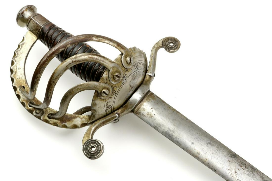 Scarce 18th-19th C. Mexican Cavalry Battle Sword.: Scarce 18th-19th C. Mexican Cavalry Battle Sword. With its complex construction steel hilt having original lining and engraved dish-guard. Strong double edged blade of oval section. Rare battle sword 