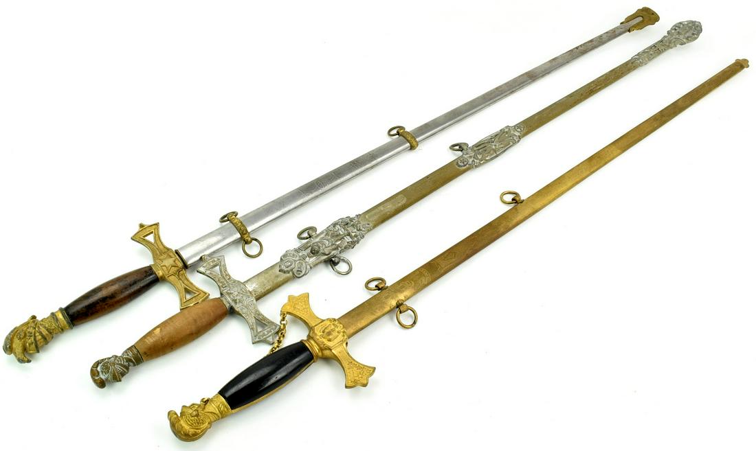 Lot of 3 Fraternal Lodge Swords, 19th-20th C.: Two swords with gilt brass one with silvered mounts, all have wooden grips. the blades are double edged, two with fine etched decorations including the owner's names and makers. All three with their o