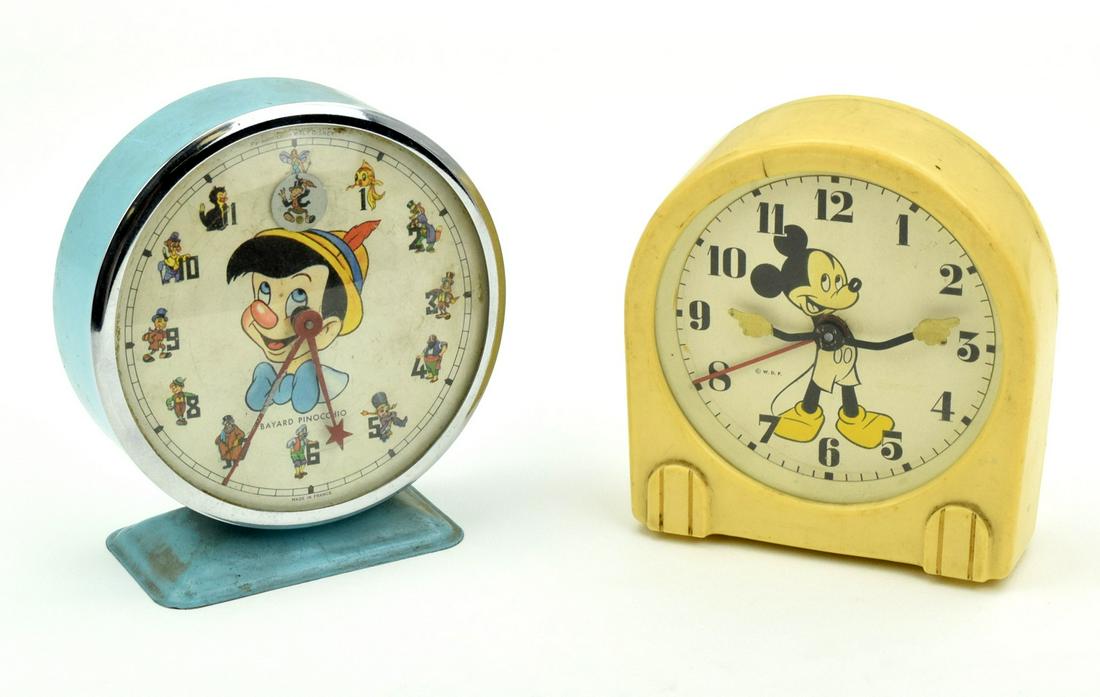 Pair Vintage Walt Disney Characters Alarm Clocks: Very fine pair of vintage Walt Disney Production clocks.1967 BAYARD DISNEY PINOCCHIO wind up character alarm clock ( made in France ) and Ingersoll US Time Corporation Mickey Mouse alarm clock c.1940'