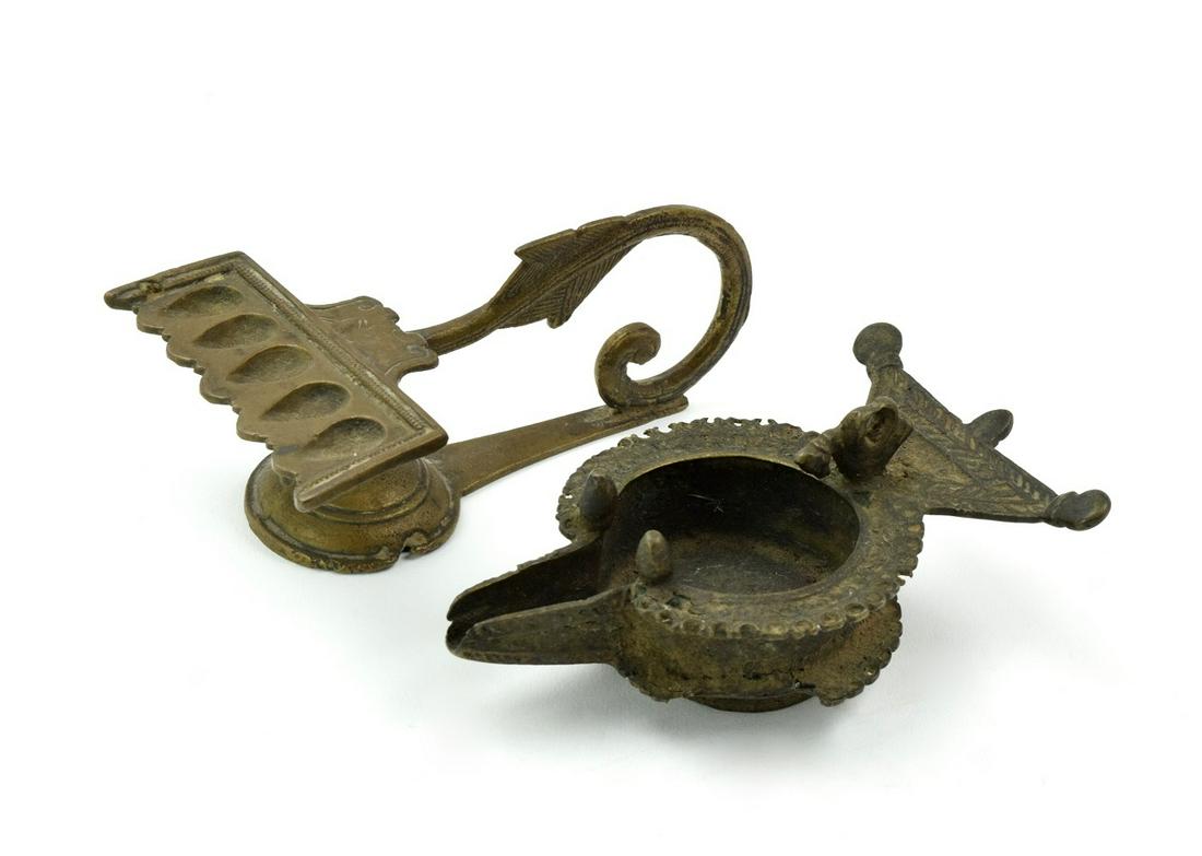 Pair Antique Byzantine Bronze Oil Lamps: Pair rare antique bronze oil lamps.One is Islamic with single nozzle, the ring handle decorated with flaring arms within an openwork.Another is multi nose with arrow shape handle.