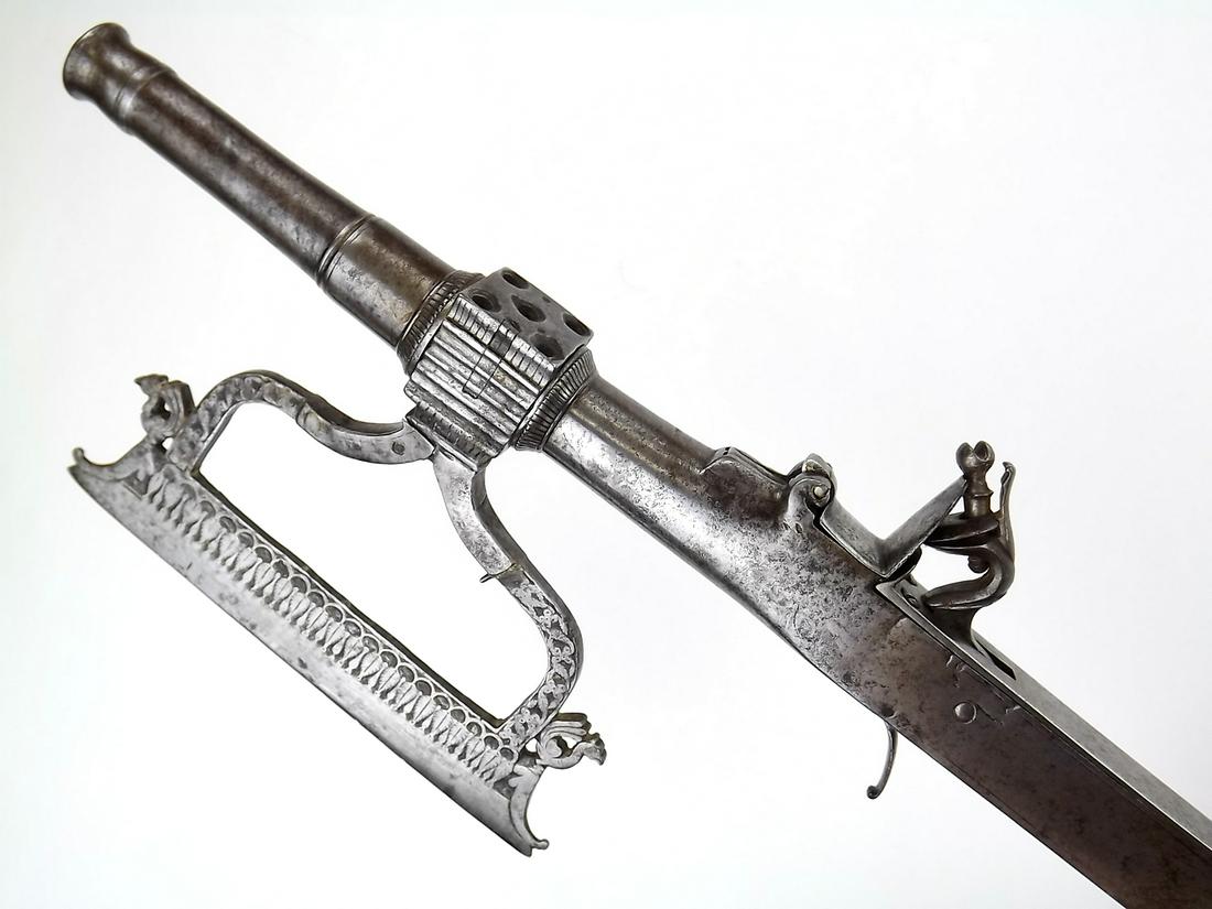 Fantastic 17th - 18th C. Mughal Indian Combination: Fantastic 17th - 18th C. Mughal Indian Combination Battle Axe Flintlock Gun and Dagger. An exceptionally rare example of an early Mughal warrior's weapon. Well forged of strong steel with chiseled dec
