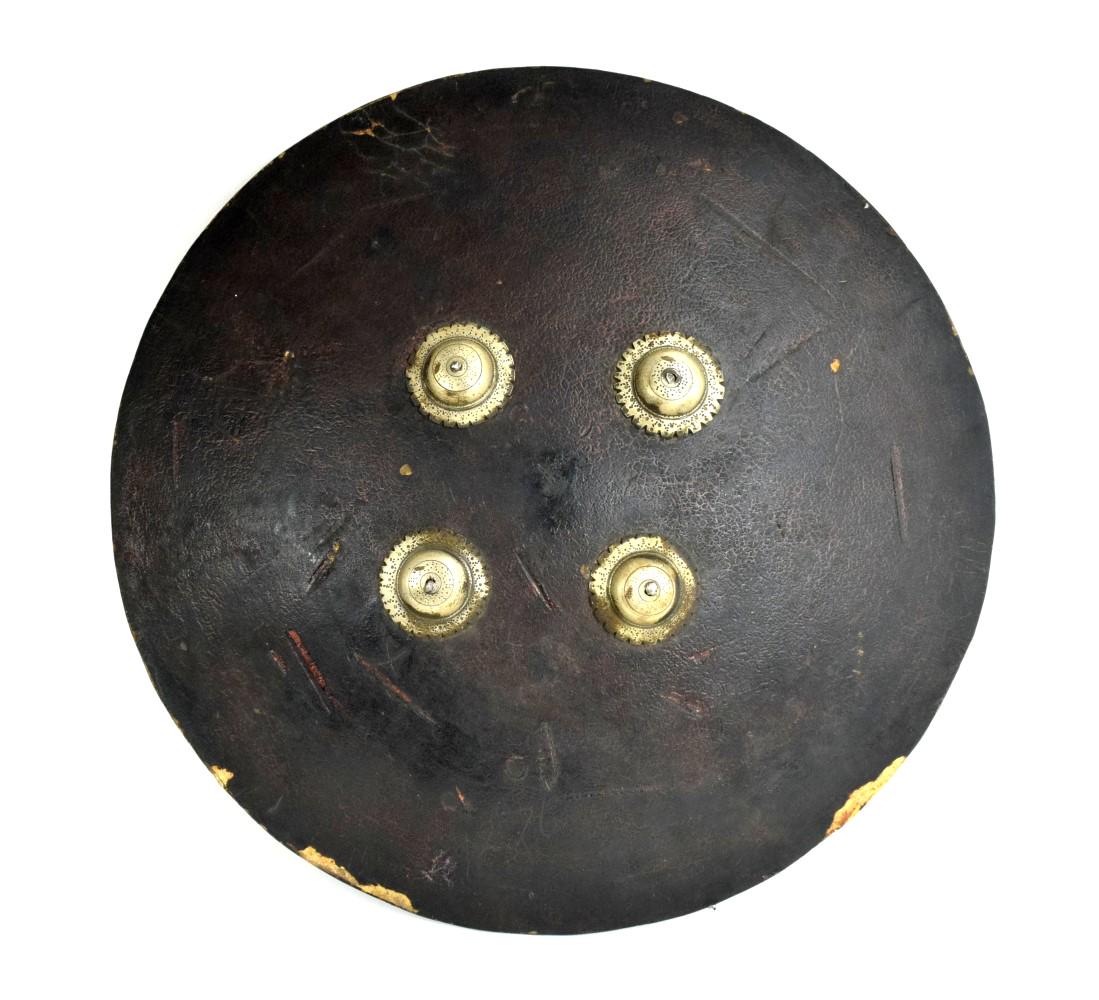 Large 18th-19th C. Mughal Indian Battle Shield of: Large 18th-19th C. Mughal Indian Battle Shield of Hardened Hide. A large and early example made of hardened animal hide with chiseled iron bosses. Diameter : 18 1/2" Detailed condition reports are not