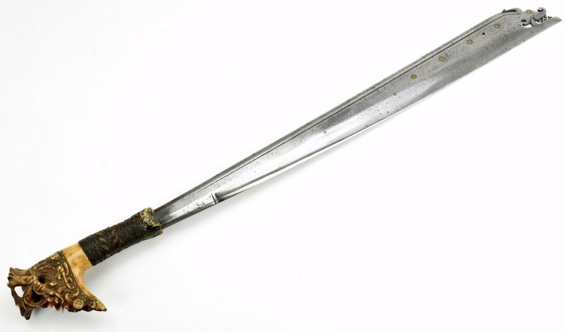 Rare Late 19th C. Indonesian Dayak Headhunters Tribe: A distinctive Bornean sword of the Sea Dayak this type of sword is called a niabor.The niabor has a convex edge and concave back broadening towards the tip in the form of acutlass and similar to the p
