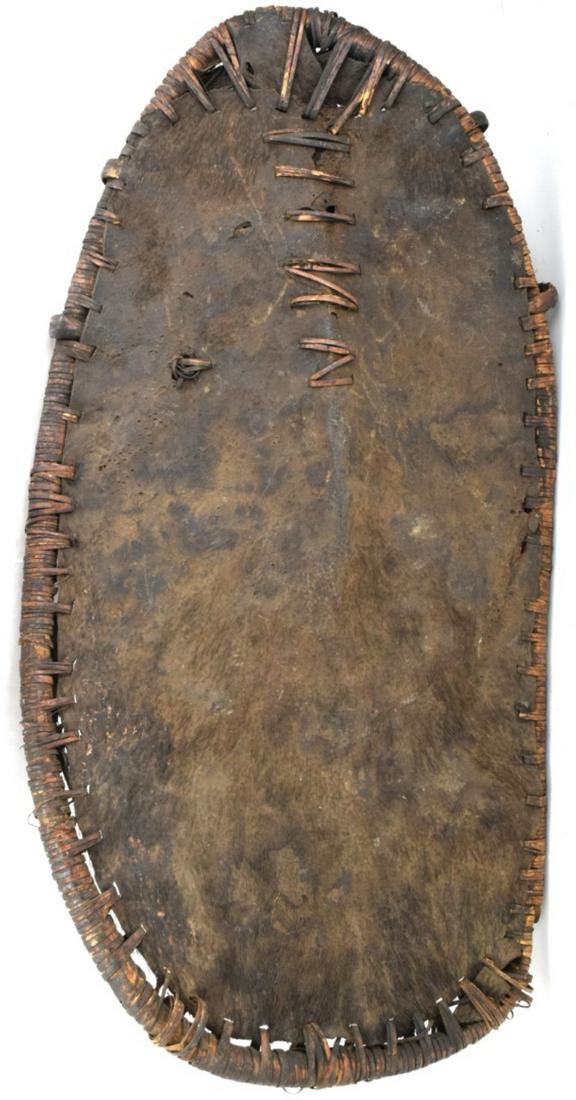 Large 19th - early 20th C. African Tribal Cowhide War: Large 19th - early 20th C. African Tribal Cowhide War Shield.Total size : 45" x 22 1/2"Detailed condition reports are not included in this catalog. For additional information, including condition repo