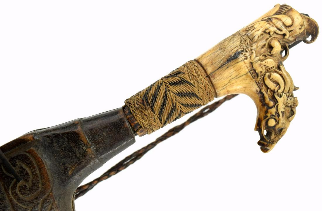 Early 20th C. Mandau Parang Ihlang Sword: A distinctive Bornean sword of the Iban Dayak, called a Mandau or Parang Ihlang, these swords are found throughout institutional and private collections in varying degrees of quality. They are disting