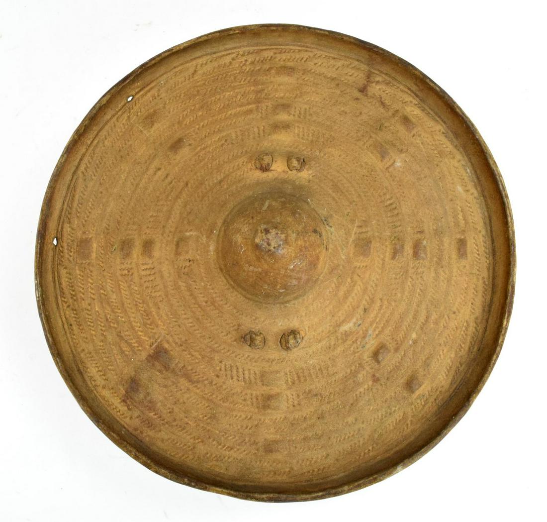 Early 20th C. Horn of Africa Somali Gaschan Shield: African cultures developed the widest and disparate groups of shield forms. From classic roundexamples to more complex profiles, the shield always played an important role in the defensivearmament of 