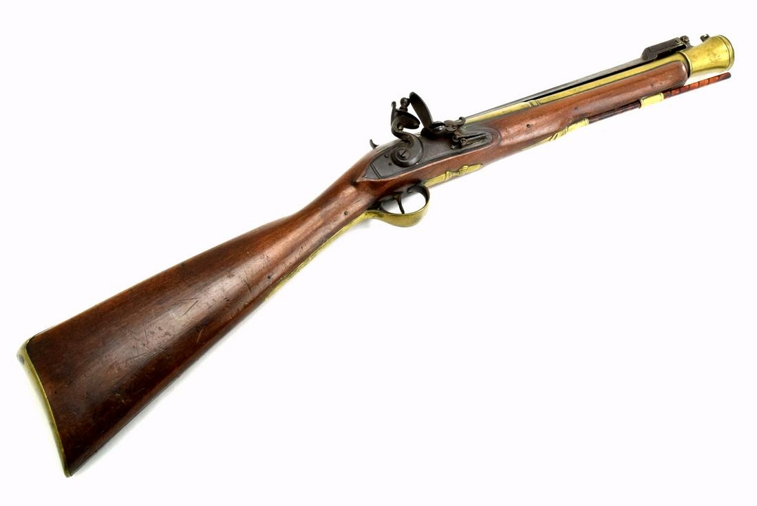 A DESIRABLE EARLY BRITISH FLINTLOCK BLUNDERBUSS,: A desirable early British flintlock blunderbuss, possibly Royal Navy used. Circa 1790s, featuring a spring loaded folding bayonet, all original and untouched, the gun is excellent condition for its ag