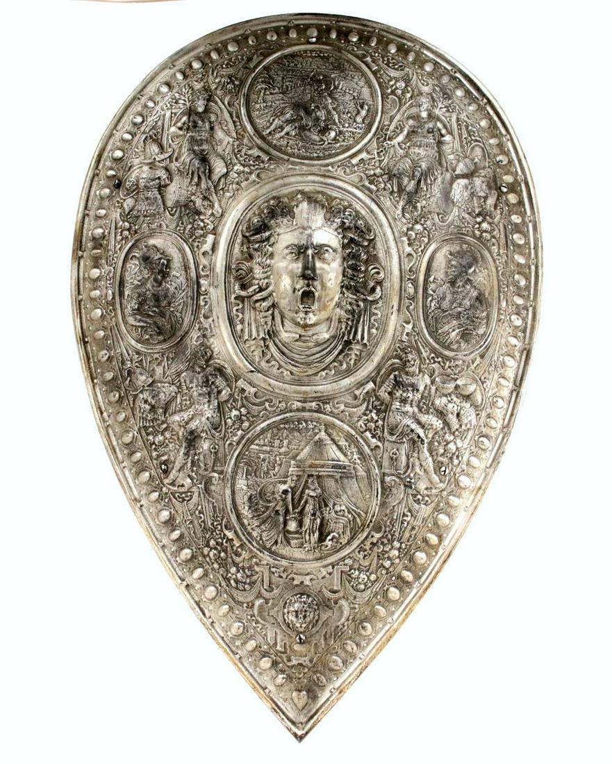 Impressive Large Iron Parade Shield in the Style of: Impressive Large Iron Parade Shield in the Style of Medieval 15th-16th C. Italian or English Royalty Armor. Diameter: 29 1/2" Width : 19 3/4". ~~ DEAR BIDDERS, Please View More Detailed Close-Up Image