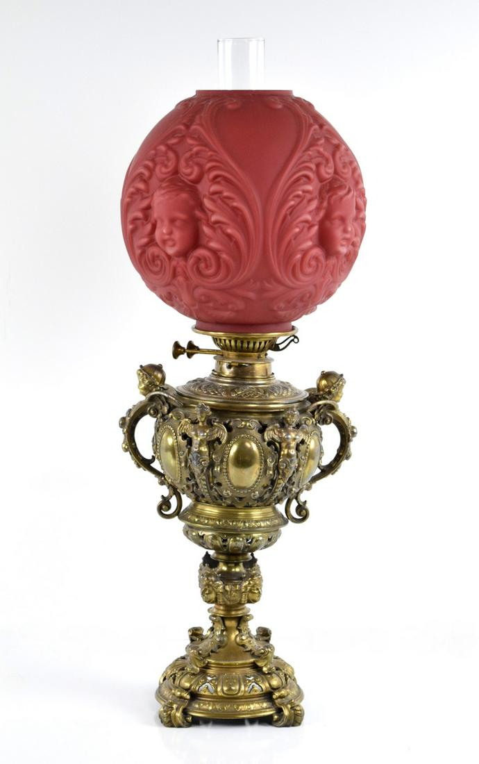 Exclusive Victorian Red Glass Globe Cherub/Baby Face Oil Table Lamp: Exclusive antique 19th Century Victorian English very ornate with red cherub face globe oil table lamp c.1890's, Amazing details with highly decorated base. All original - NOT electrified. Marked on t