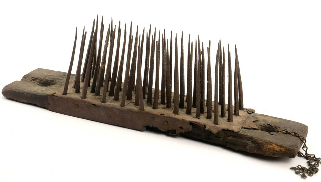 The Whole or an Element of a Medieval era European Torture Device, comprised of an Iron Covered: The Whole or an Element of a Medieval era European Torture Device, comprised of an Iron Covered Wooden Board with Rows of Very Long Iron Nails. Board size : 13" x 3 1/2" Nail length : ~ 4" ~~ DEAR BID