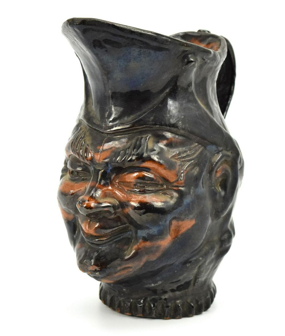Old Mexican Folk Art Pulgue Pottery Pitcher: Rare unique antique folk art Mexican Pulgue pottery pitcher depicting face of one of Mexicans national heroes. Black glazed with brown color spots. Rare find piece of Mexican history. 10 1/4" height a
