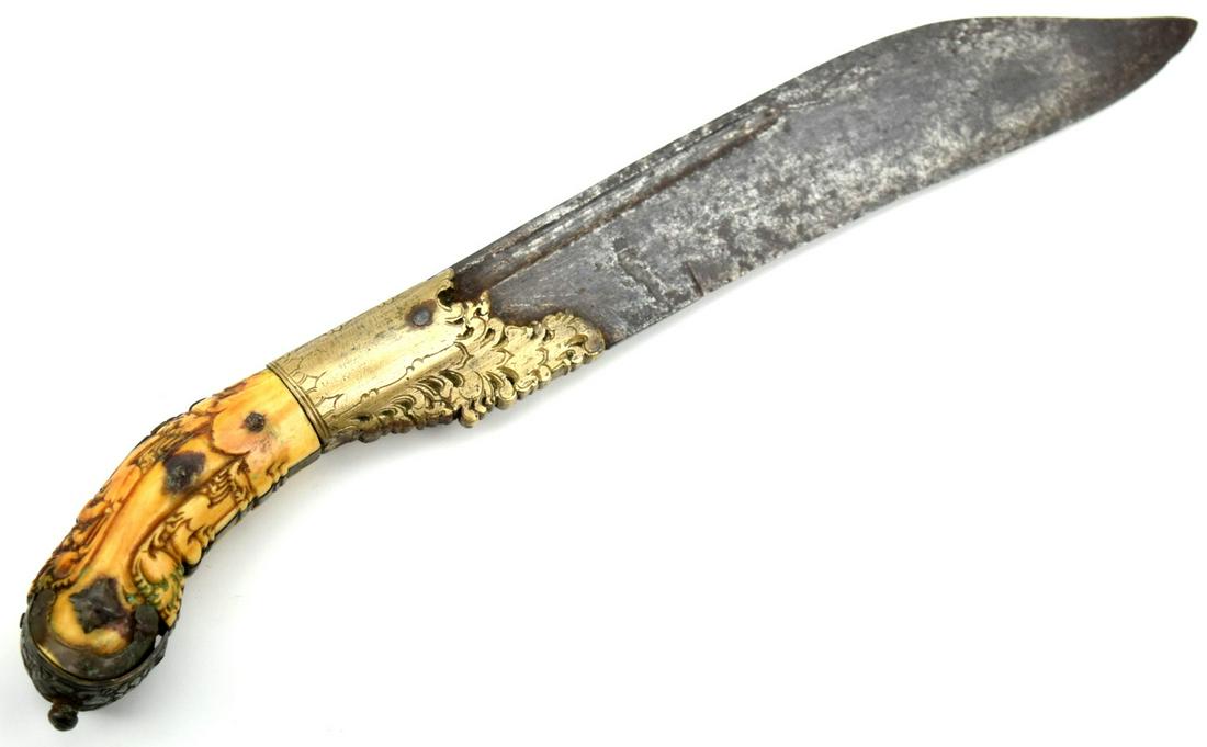 Good 19th C. Piha Kaetta Dagger with Massive Blade: A massive example of typical form, with silver-mounted elephant grip incised and engraved overall. Heavy, single-edged blade with deep fullers. 19th century. Total length : 10 1/2", Blade length : 8".