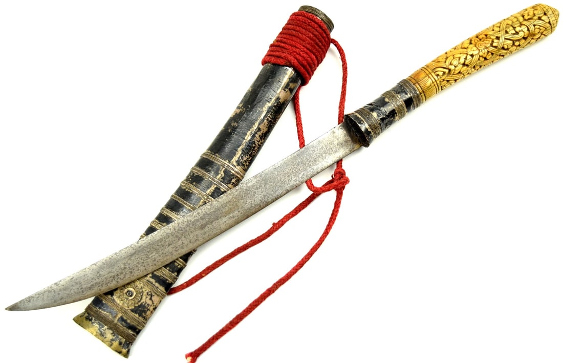 Very Good 19th C. Burmese Thai DHA Sword w Carved Handle: An Impressive antique Burmese mid 19th century, Dha short sword and scabbard. Sword features an intricately carved and pierced bone handle, strong blade and original scabbard completed with silver har