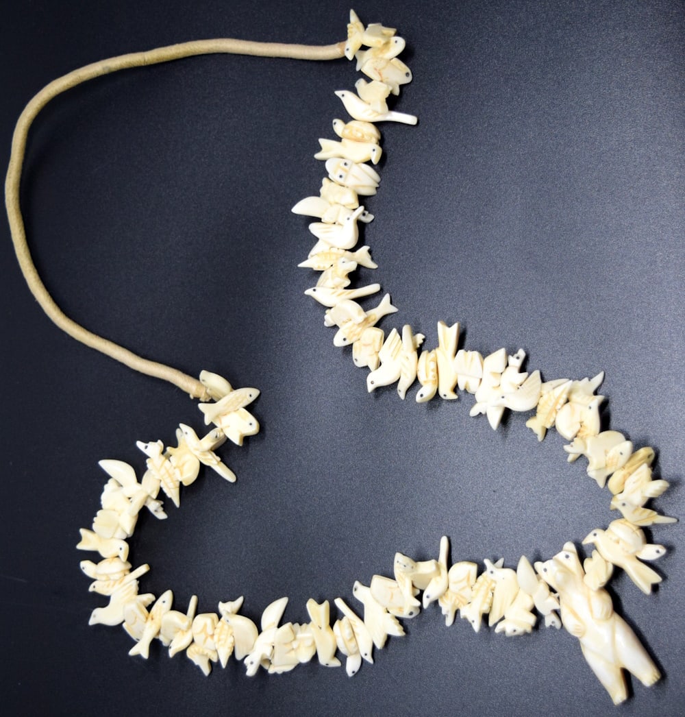 Eskimo Inuit Carved Walrus Bone Fetish Necklace: This is a beautiful antique necklace hand-made by the Inuit peoples, indigenous to Canada and Alaska. The necklace is finely crafted and detailed. It is composed of multiple fetish Inuit birds, fish a