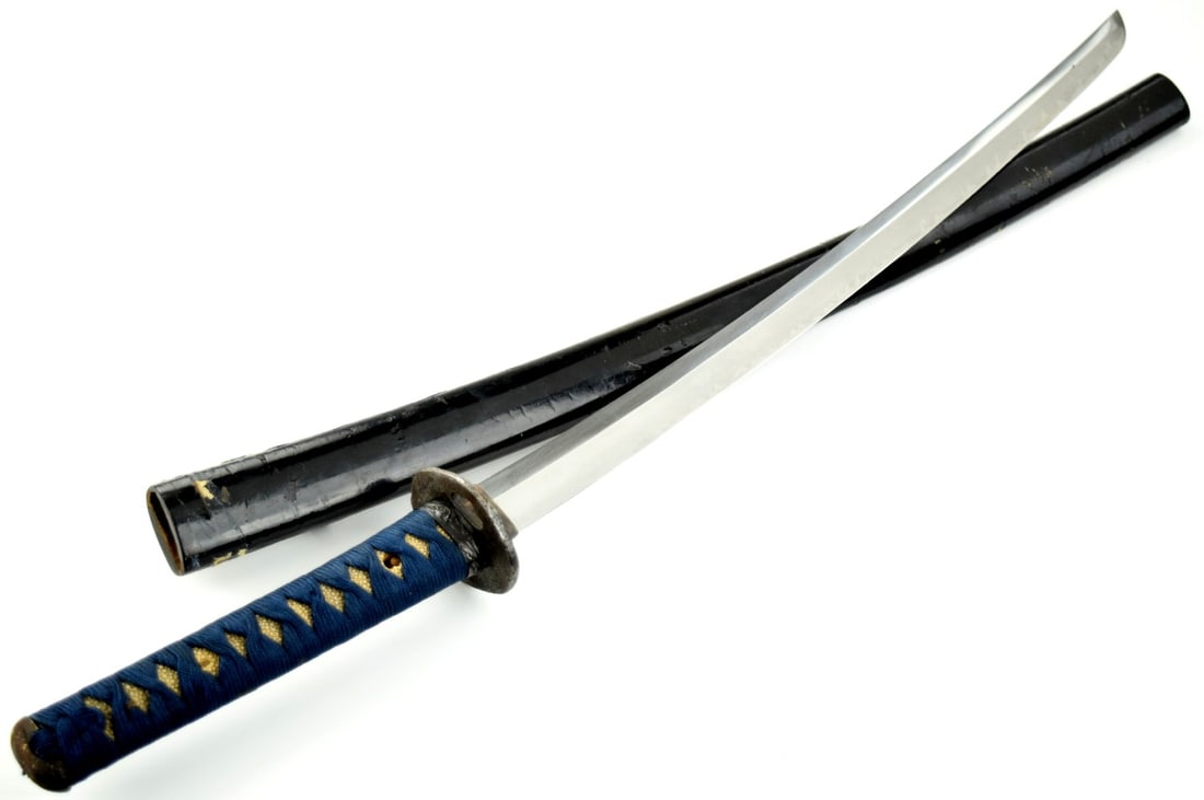 Interesting Edo era Japanese Samurai Wakizashi Sword with Markings on the Spine Edge of the Tang: Interesting Edo era Japanese Samurai Wakizashi Sword. on the Spine Edge of the Tang markings from the arsenal of a samurai leader. Very Unusual Hamon. Early Iron Tsuba, Later Mounts. Total length (ins