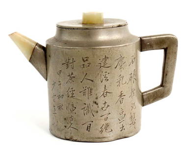 Chinese Incised Pewter and Jade Teapot: Chinese pewter Yixing teapot. The pewter incised with calligraphy, cover finial and spout in celadon jade. Great original antique patina.Size: 4 1/4" x 3 3/8". Detailed condition reports are not inclu