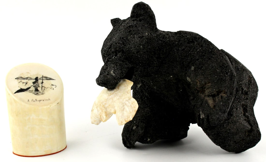 Group Arctic Eskimo Ossified Bone Bear and Signed Scrimshaw Paperweight .: Carved bear holding the fish made from ossified bone. Comes with nice signed by Inuit artist scrimshaw paperweight. SIZE: L: 7 5/8", H: 5", W: 5 1/4"(bear); SIZE: L: 2 5/8", H: 3 7/8", W: 1 3/4". NO I