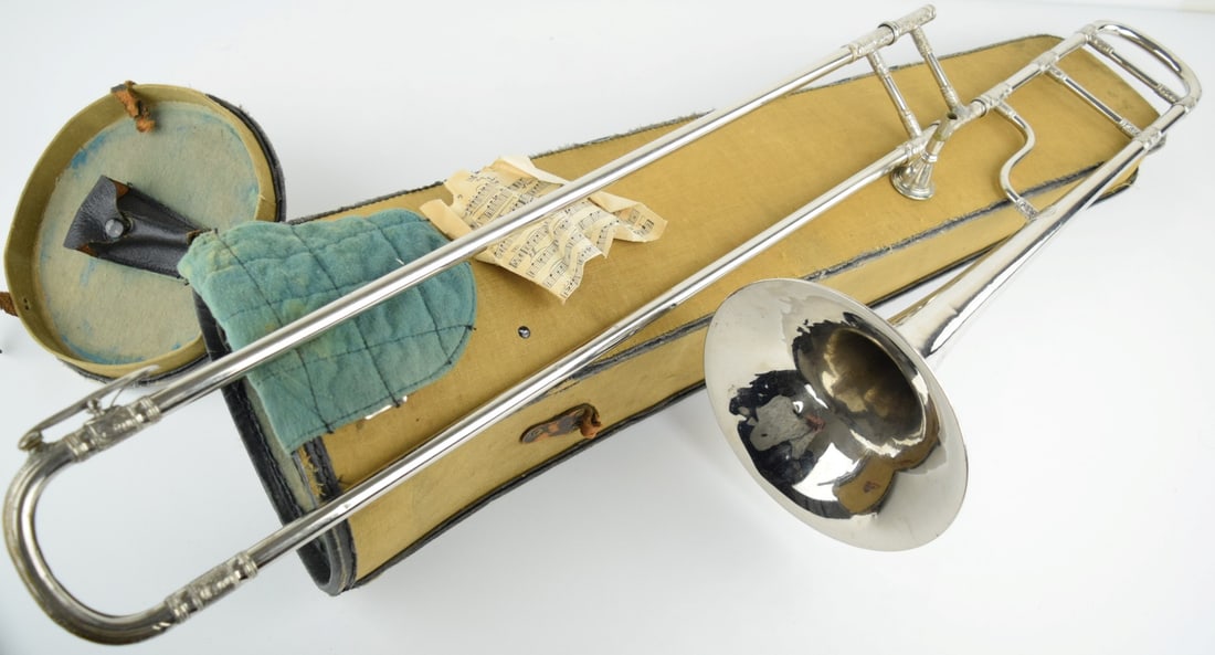 Beau Ideal Stencil Lyon & Healy Engraved Silver Trombone: A gorgeous Lyon and Healy Beau Ideal trombone. Late 1800's. Very fine fancy engraving. Comes with original case. Case Size: 34 1/2". Detailed condition reports are not included in this catalog.